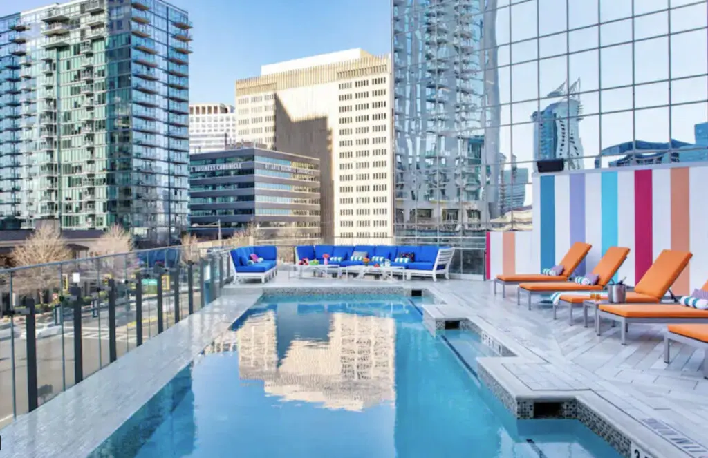 Hotel Colee Atlanta hotel rooftop infinity pool with colorful chairs and view