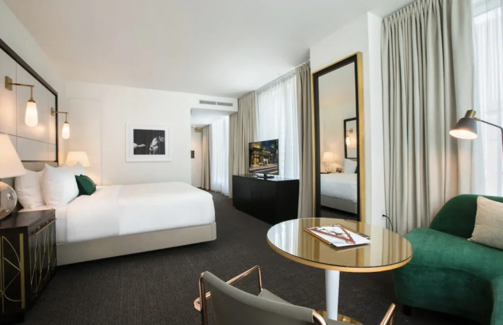 The Laura Hotel room design sophisticated elegant gold and green hotel room